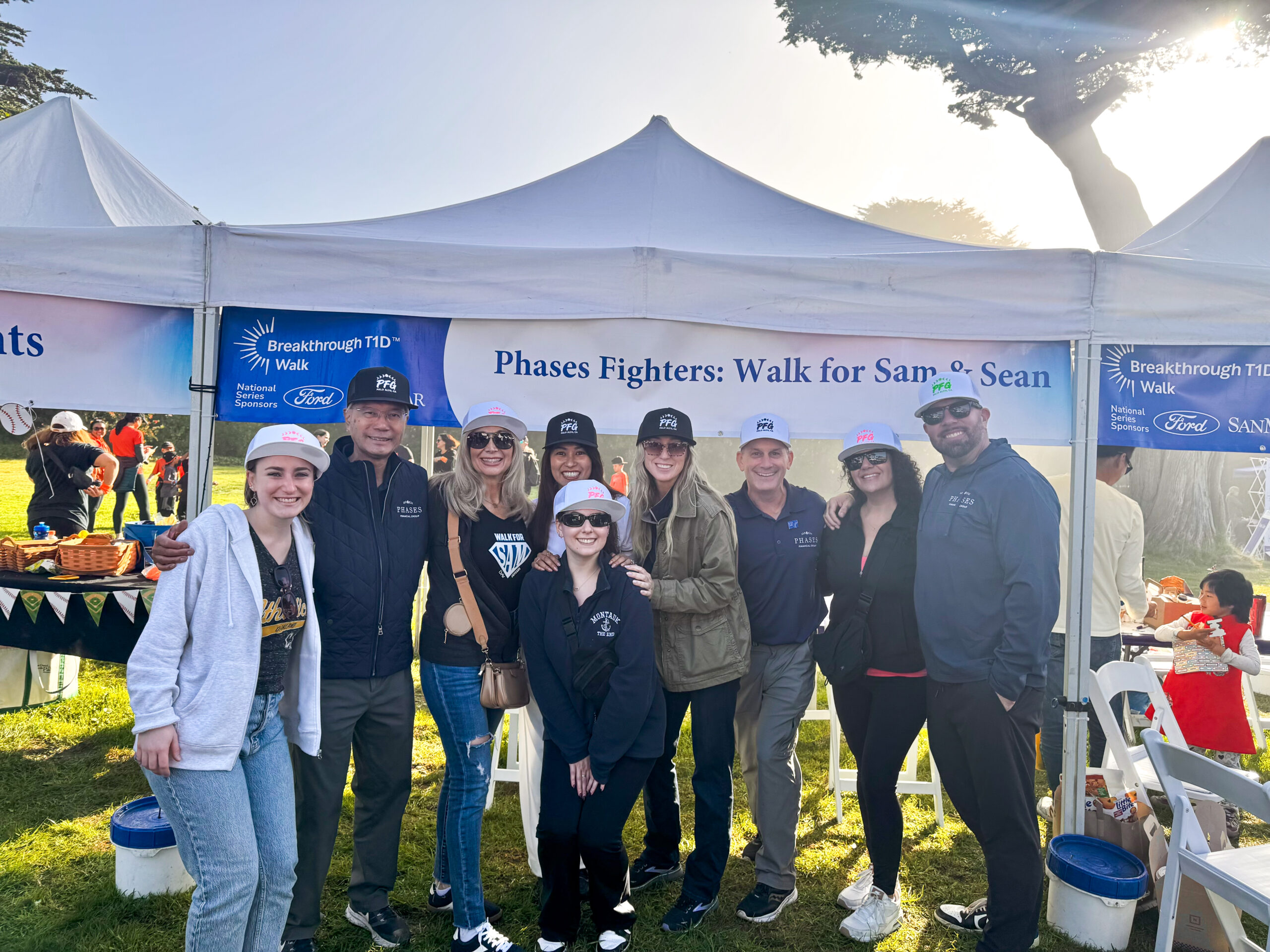 Phases Financial Group's team and clients gather under the 'Phases Fighters: Walk for Sam & Sean' banner at the Breakthrough T1D Walk.